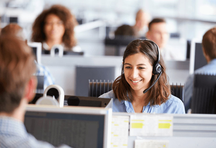 a young woman answers the phone in an office